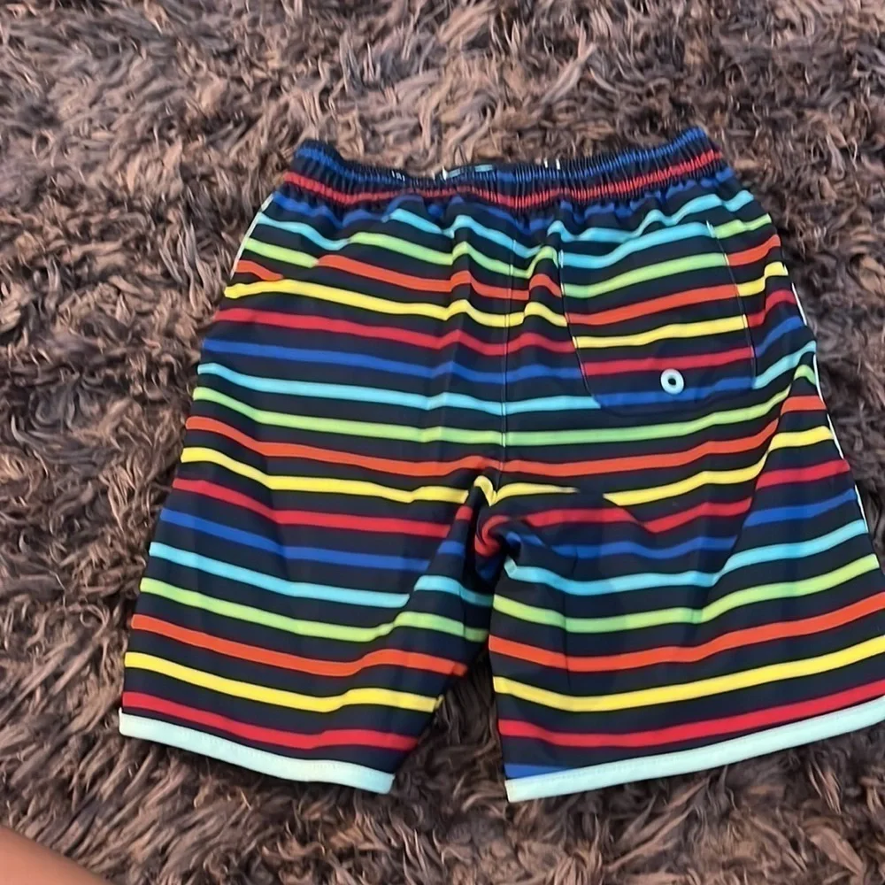 Wonder nation size 4T swim trunks.  Blue background with colorful stripes